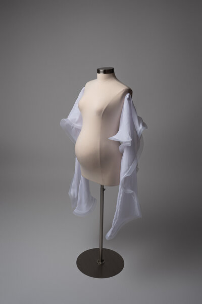 Pregnant woman wearing a statement pearl shoulder piece in a fine art maternity photo