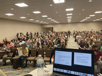 literacy consultant speaking to a group of educators at a national conference