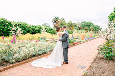 bride and groom smile at each other leaning forehead to forehead with eyes closed