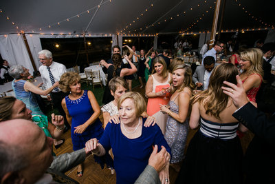 Tent wedding guests dancing bubble lights