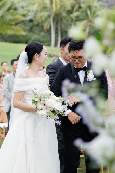 A couple with linked arms during their wedding ceremony 