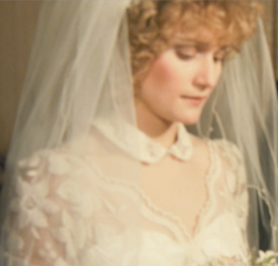 Bride holding flowers playing with her hair