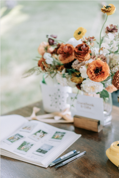 photo of guest book and wedding flowers