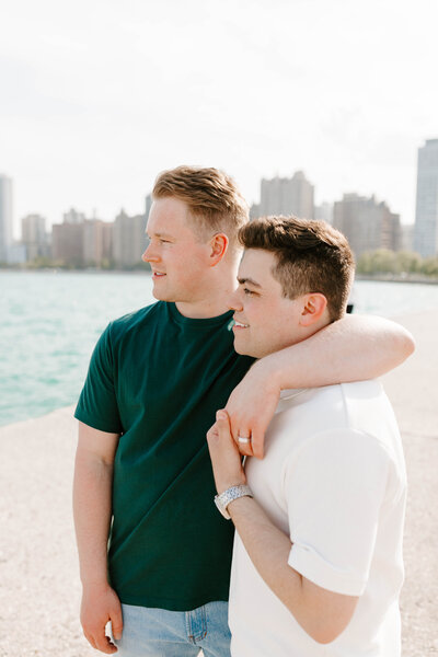 Two men standing with their arms around each other