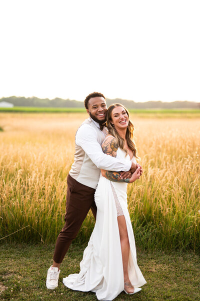 A young woman in a white dress with her fiancé
