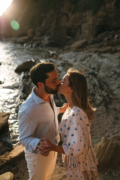 Couple kiss at sunset at Saunton Sands in Devon