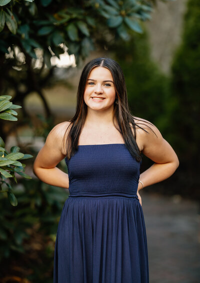 Senior girl in blue dress smiles at camera in Beverly, Massachusetts