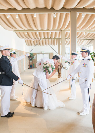 military couple dip kiss at monterey beach station wedding