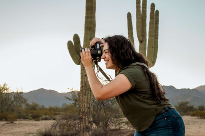 Cactus & Pine Photography owner taking a photo with camera