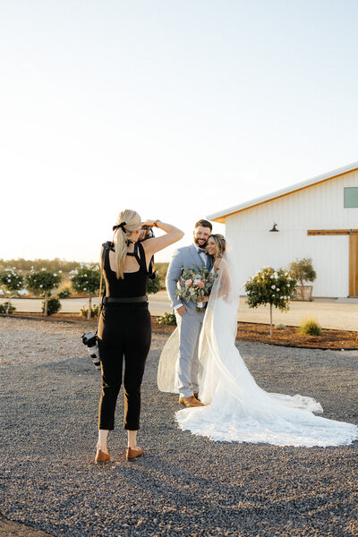 Wedding and Elopement Photographer, image of Shannon take a picture of bride and groom