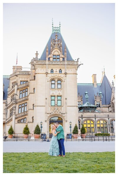 engaged couple posing in front of Biltmore Estate in Asheville, North Carolina photographed by Asheville Engagement Photographer