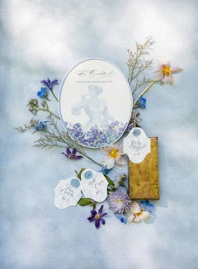 A flatlay with invitation and flowers at the Swan House in Atlanta, GA