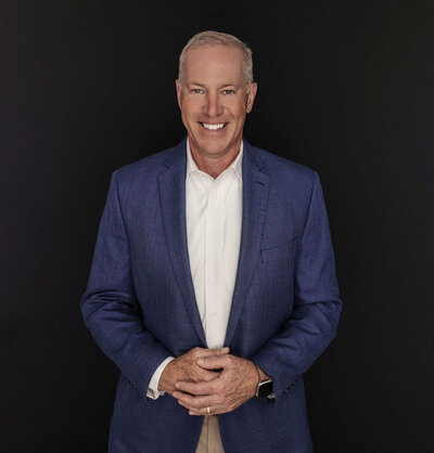 Mark Sullivan in a navy sports jacket and white shirt smiling confidently – Life and Health Coach at LifeNBalance Coaching12