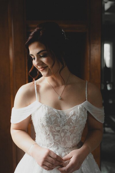 Bride standing near a window at The Norland Historic Estate in Lethbridge Alberta