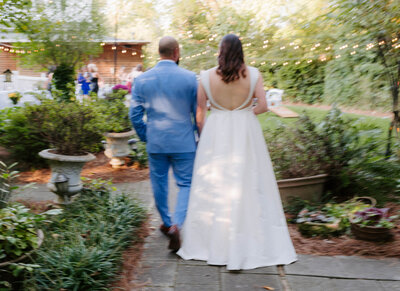 Bride and groom walk to wedding reception