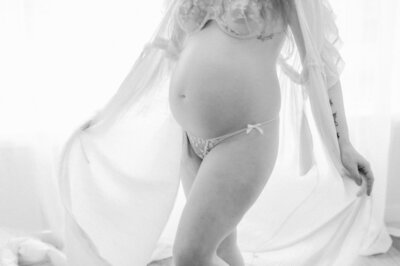 expectant mother swaying with her belly in seattle newborn photography studio