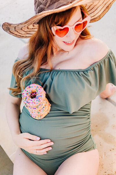 pregnancy photography in flower. mound with donuts pool side