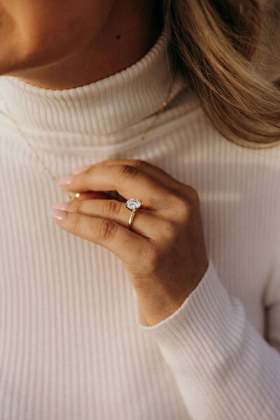 photo of woman wearing her engagement ring while touching her necklace taken by Grand Teton wedding photographer