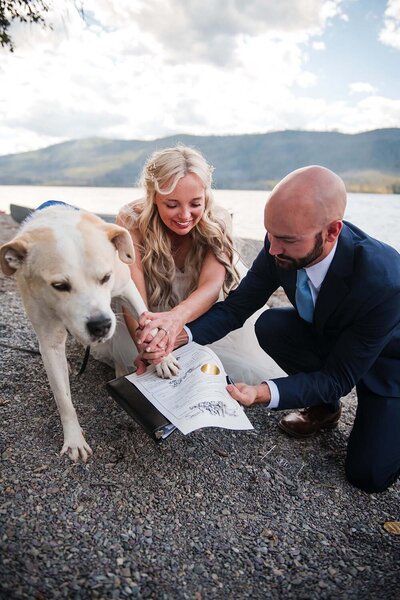 A happy couple witness their marriage license with their dog in Montana.