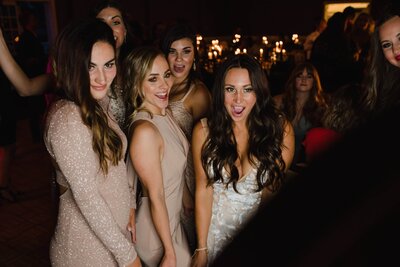 wedding guests using a photo booth at a wedding