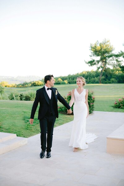 Bride and groom walking and holding hands