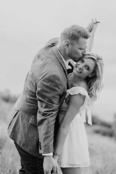 man and woman dancing in grass field