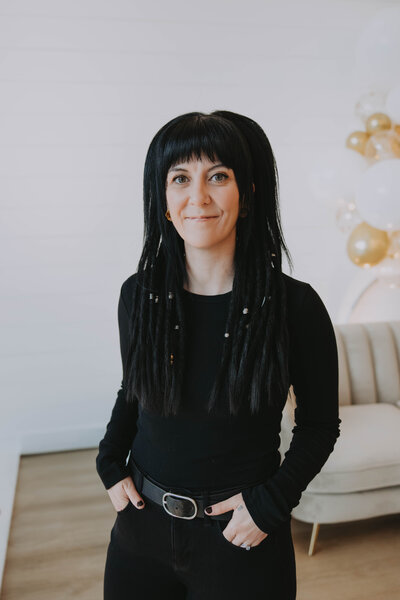 Rocky Mountain Weddings Creative Director inside smiling in The Gem Event Centre Located By Banff and Canmore