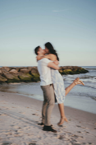 man and woman embracing on the beach