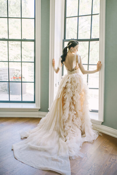 bride-standing-looking-out-window