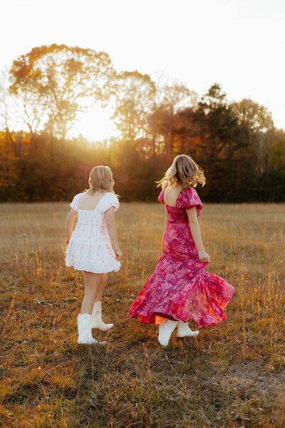 two senior friends twirling around for outdoor senior session
