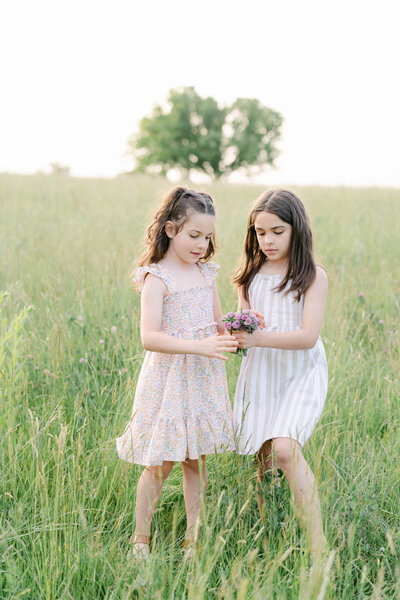mother spins in a dress holding her new baby during a photo session in Delaware