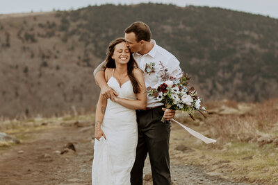 photo of bride and groom embracing after their mountaintop elopement in asheville