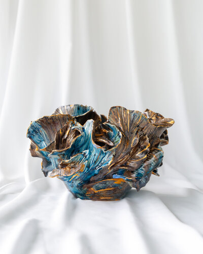 Handmade ceramic sculpture of an elegant figure by Gerda Satunas, captured with high-quality product photography.