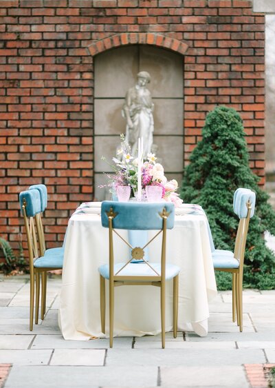 Beautiful table with blue chairs in courtyard