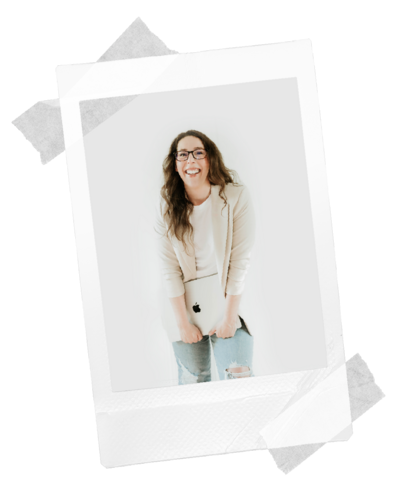 Amanda Newman graphic and. website designer smiling holding a laptop.