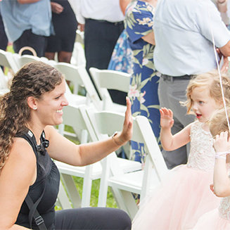 photographing giving high fives to flower girls