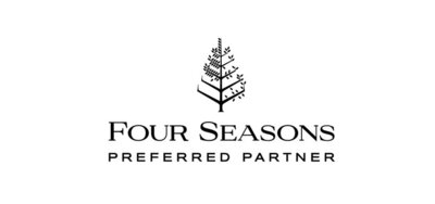 Logo for "Four Seasons Preferred Partner" featuring a stylized black tree graphic above the text. The tree has symmetrical, branch-like designs and the text is in a refined serif font, all set against a white background.
