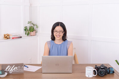 Visual Branding Audit - A woman is sitting and working on her laptop.