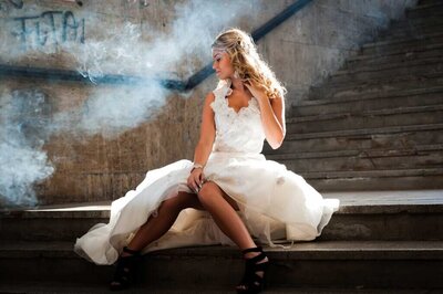 bride sitting on stairs thining about wedding photography costs
