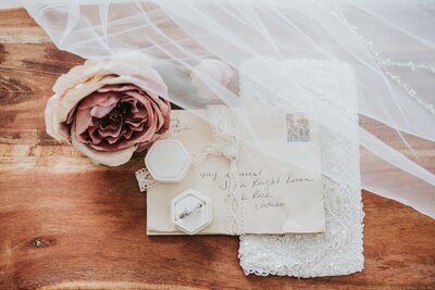 Big Sur wedding photographer captures beachy bridals and intricate wedding details with wedding invitations and florals