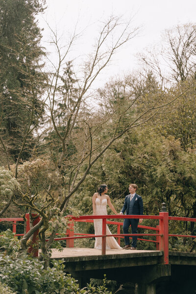 bride and groom holding hands at kubota garden