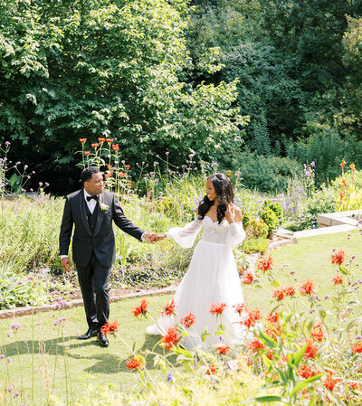 Couple holding hands walking through the garden at Callanwolde Photo Elizabeth Austin