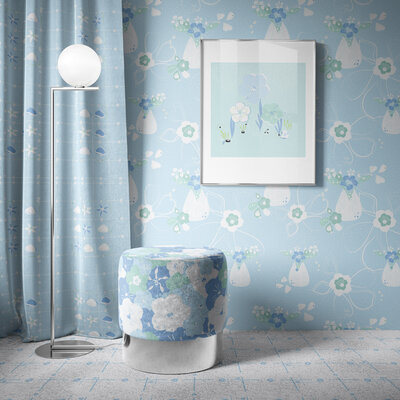 Room with blue patterned wallpaper and a patterned fabric covered ottoman