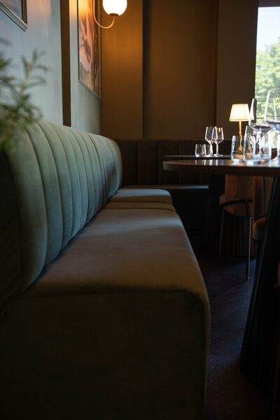 Elegant dining room at Revé in Niagara-on-the-Lake featuring an open live-fire hearth and modern design
