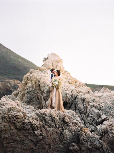bride and groom on cliff