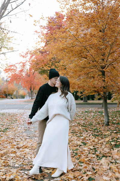 Couple walking hand in hand through Harrison Blvd in Boise Idaho