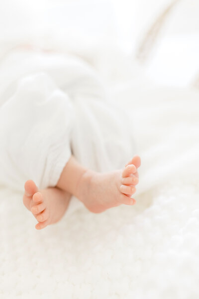 Baby feet in natural white studio space