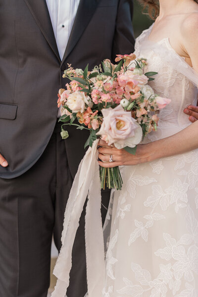 ethereal bridal portrait of woman holding bouquet and walking in the wind