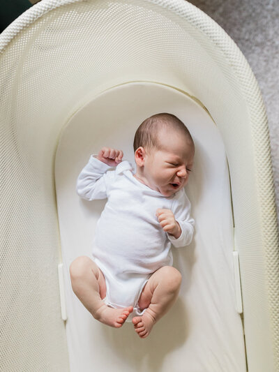 newborn baby boy in bassinet