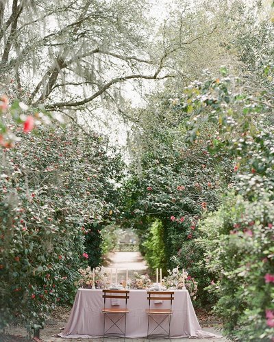 Camellia garden sweetheart table with blush velvet linen and wooden slat bistro chairs